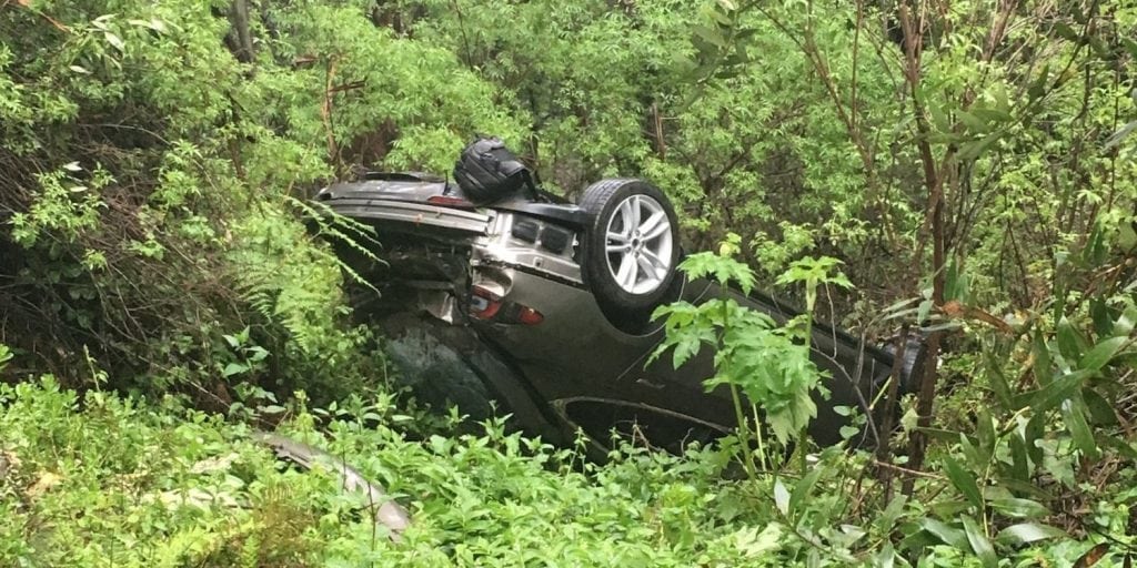 Tesla Model S upside down in a trail